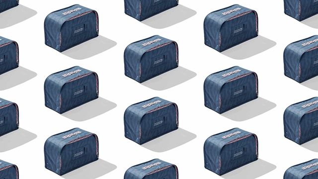 Stacked blue rental clothing boxes in a repetitive pattern suggesting organized logistics and delivery services.